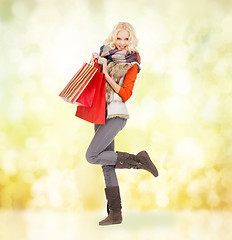 Image showing teenage girl in winter clothes with shopping bags
