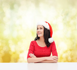 Image showing surprised woman in santa helper hat looking up