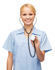 Image showing smiling female doctor or nurse with stethoscope