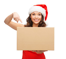 Image showing smiling woman in santa helper hat with parcel box