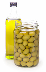 Image showing Green olives preserved in bank and a bottle of olive oil