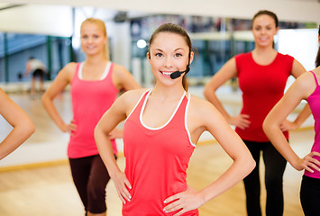 Image showing group of smiling people exercising in the gym