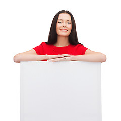 Image showing smiling young woman with blank white board