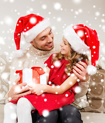 Image showing smiling father and daughter holding gift box