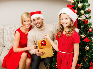 Image showing smiling family decorating christmas tree