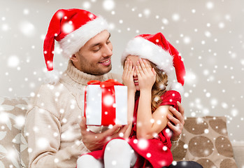 Image showing smiling daughter waiting for a present from father