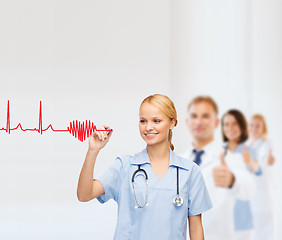 Image showing smiling doctor or nurse drawing electrocardiogram