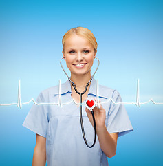 Image showing smiling female doctor or nurse with stethoscope