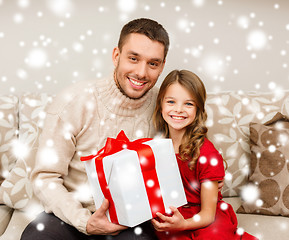 Image showing smiling father and daughter holding gift box