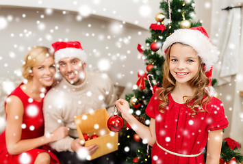 Image showing smiling family decorating christmas tree