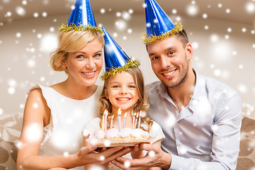 Image showing smiling family in blue hats with cake