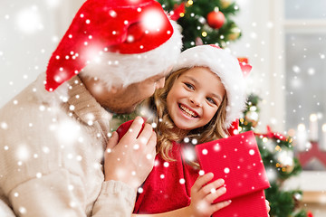 Image showing smiling father and daughter opening gift box