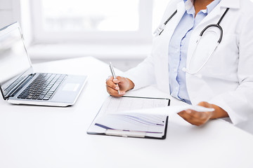 Image showing female doctor writing prescription