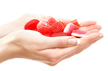 Image showing hands full of red bonbons