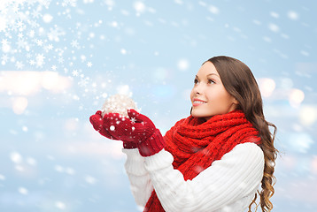 Image showing woman in scarf and mittens with christmas ball