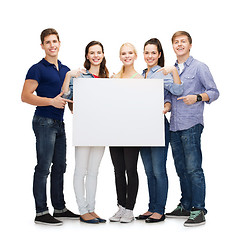 Image showing group of smiling students with white blank board