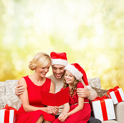 Image showing smiling family reading postcard