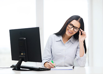 Image showing smiling businesswoman or student with eyeglasses