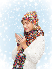 Image showing woman in hat with red tea or coffee mug