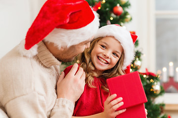 Image showing smiling father and daughter opening gift box