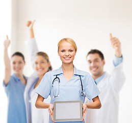 Image showing smiling female doctor or nurse with tablet pc