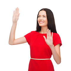 Image showing woman in red dress working with virtual screen