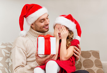 Image showing smiling daughter waiting for a present from father