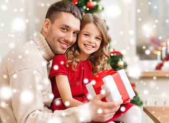 Image showing smiling father and daughter holding gift box