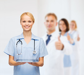 Image showing smiling female doctor or nurse with tablet pc
