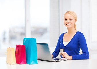 Image showing woman with shopping bags, laptop and credit card