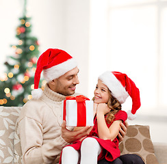 Image showing smiling father giving daughter gift box