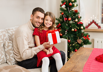 Image showing smiling father and daughter holding gift box