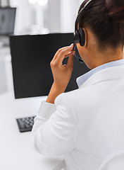 Image showing friendly female helpline operator with headphones