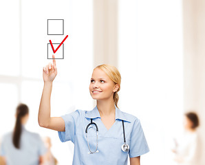 Image showing doctor or nurse drawning checkmark into checkbox