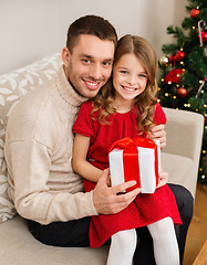 Image showing smiling father and daughter holding gift box