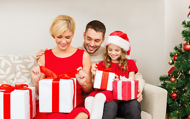 Image showing happy family opening gift boxes