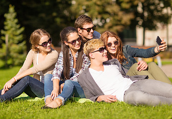 Image showing teenagers taking photo outside with smartphone