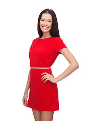 Image showing smiling young woman in red dress