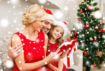 Image showing smiling family reading book