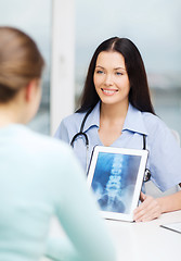 Image showing doctor or nurse showing x-ray with tablet pc