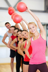 Image showing group of smiling people working out with ball