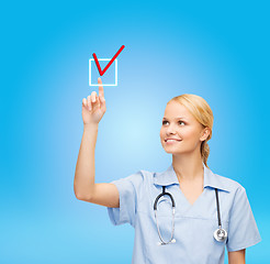 Image showing smiling doctor or nurse selecting