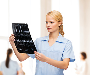 Image showing serious doctor or nurse looking at x-ray