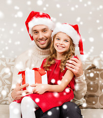 Image showing smiling father and daughter holding gift box