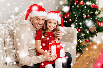 Image showing smiling father and daughter holding gift box