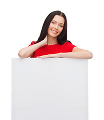 Image showing smiling young woman with blank white board