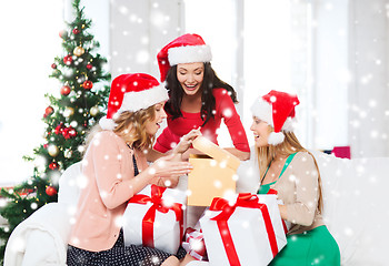 Image showing women in santa helper hats with many gift boxes