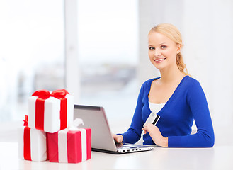 Image showing woman with gifts, laptop computer and credit card