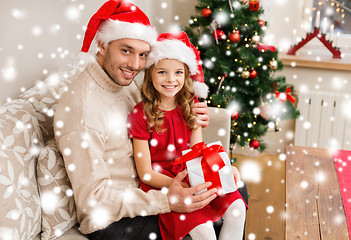 Image showing smiling father and daughter holding gift box