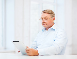 Image showing old man with tablet computer at home